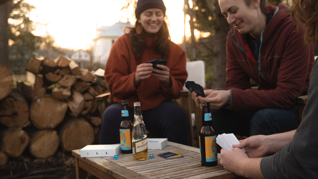 Friends playing Lark in the backyard with a fire and drinks